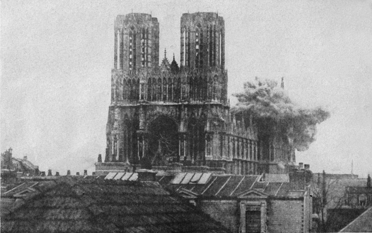 September 19<sup>th</sup> , 1919 — the first German shell bursts on the cathedral during the First World War. "The Cathedral of Notre Dame at Rheims was one of the most beautiful buildings in the world. The framework was still standing when the Germans began their drive in 1918. In this instance shells burst on the cathedral before the eyes of many spectators."